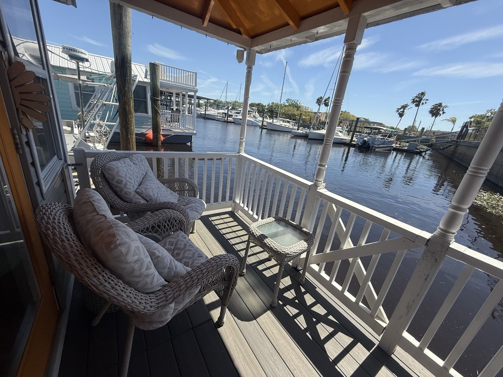 Private covered porch overlooking the marina and river