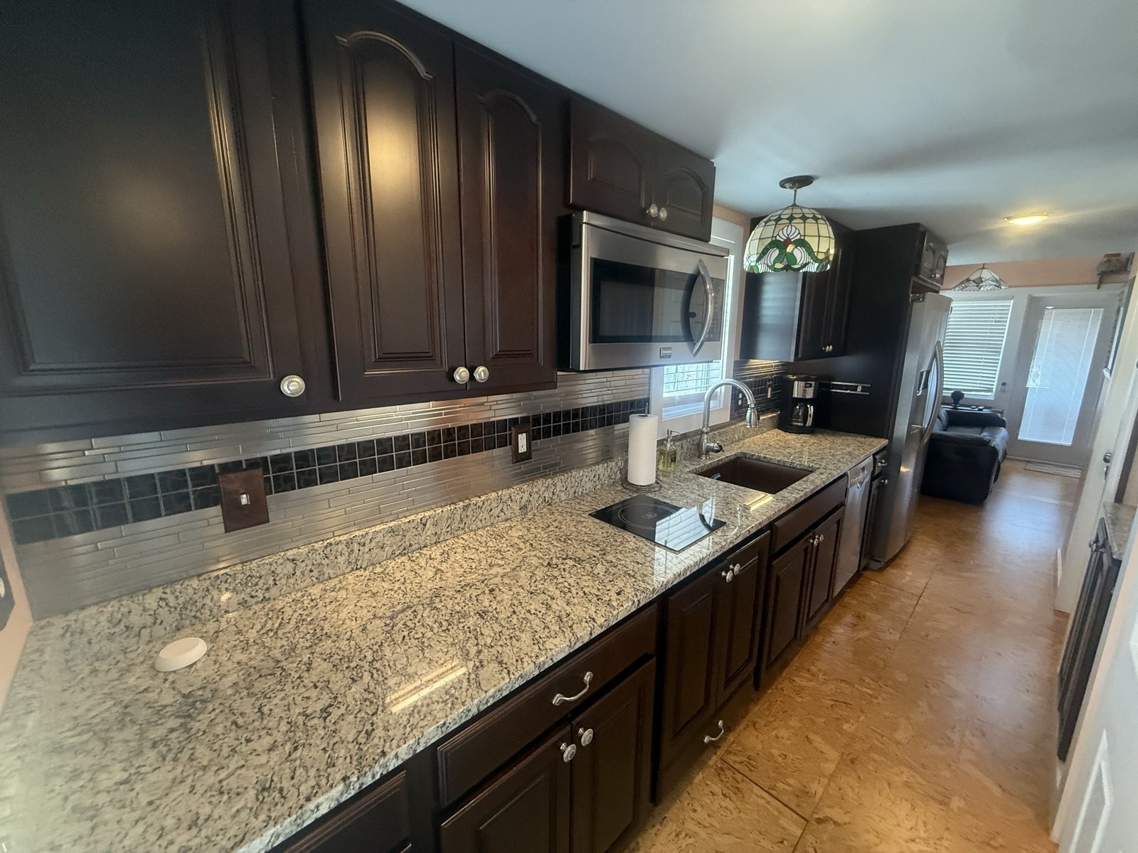 Fully equipped kitchen with cooktop, microwave, and dishwasher